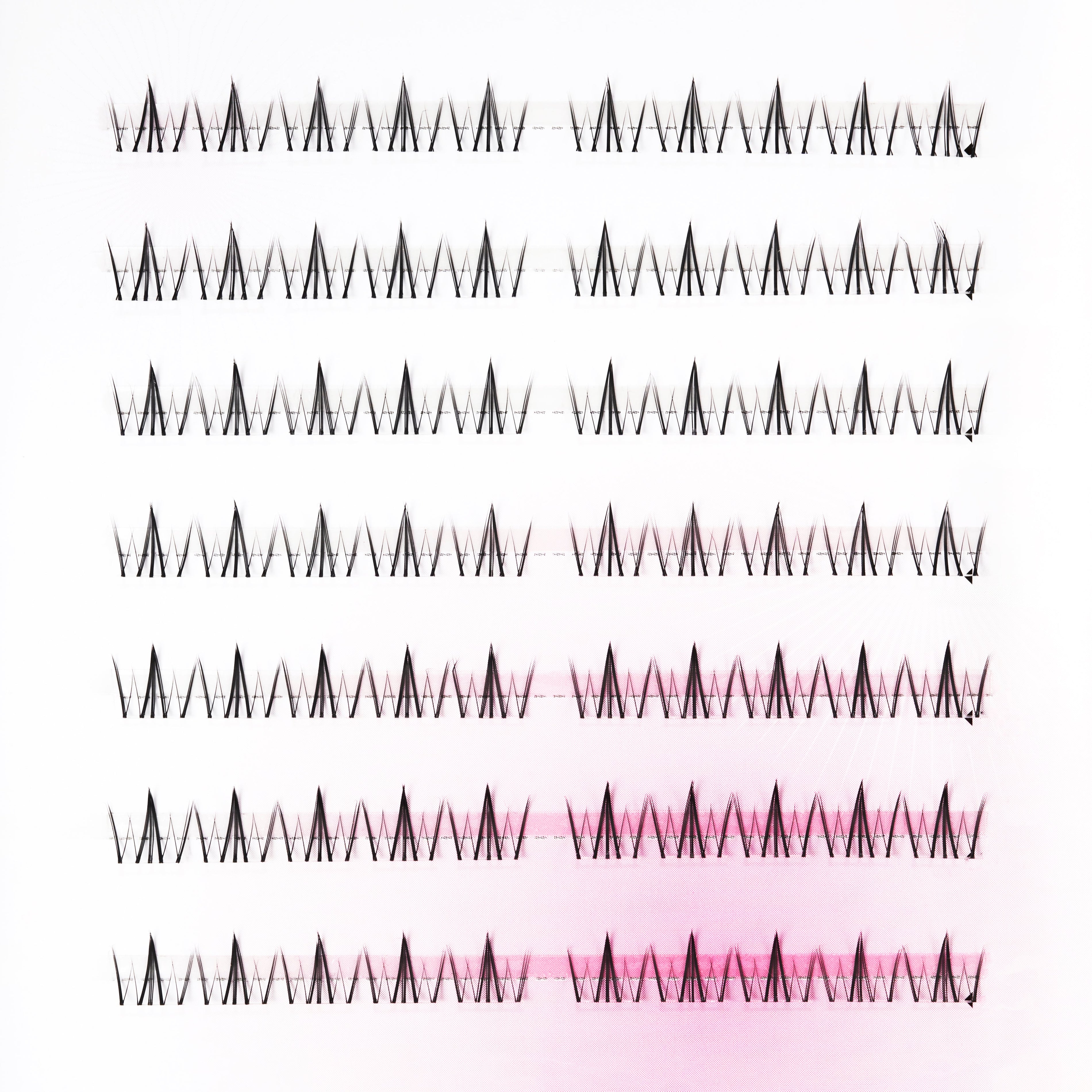 Multiple rows of handmade false eyelash extensions arranged on a white background
