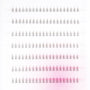 Multiple rows of handmade individual eyelash extensions on a white and pink tray background