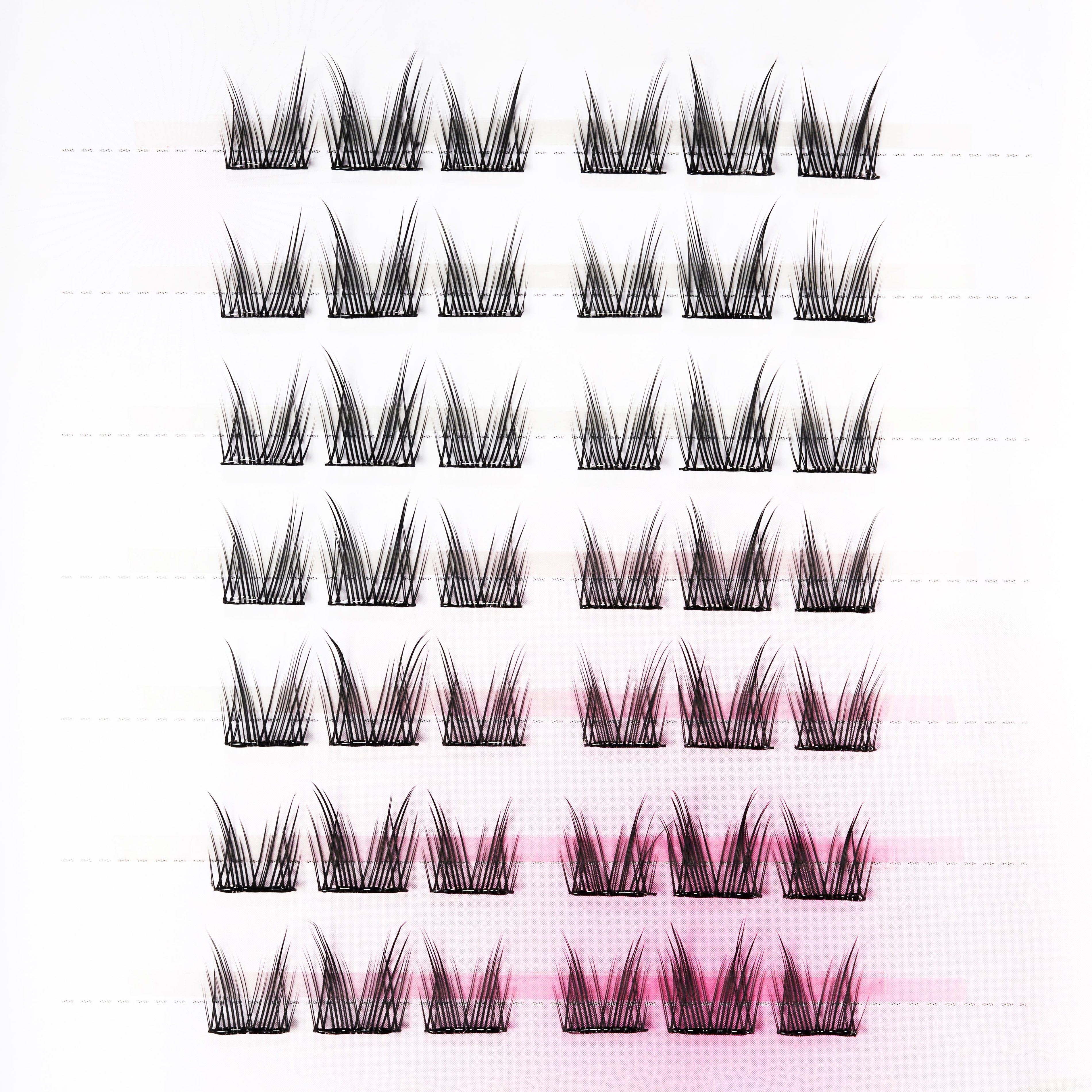 Set of black handmade lash clusters arranged in rows on a white background for easy application.