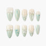 Handmade press-on nails in pastel mint and white with bow, pearl, and flower designs