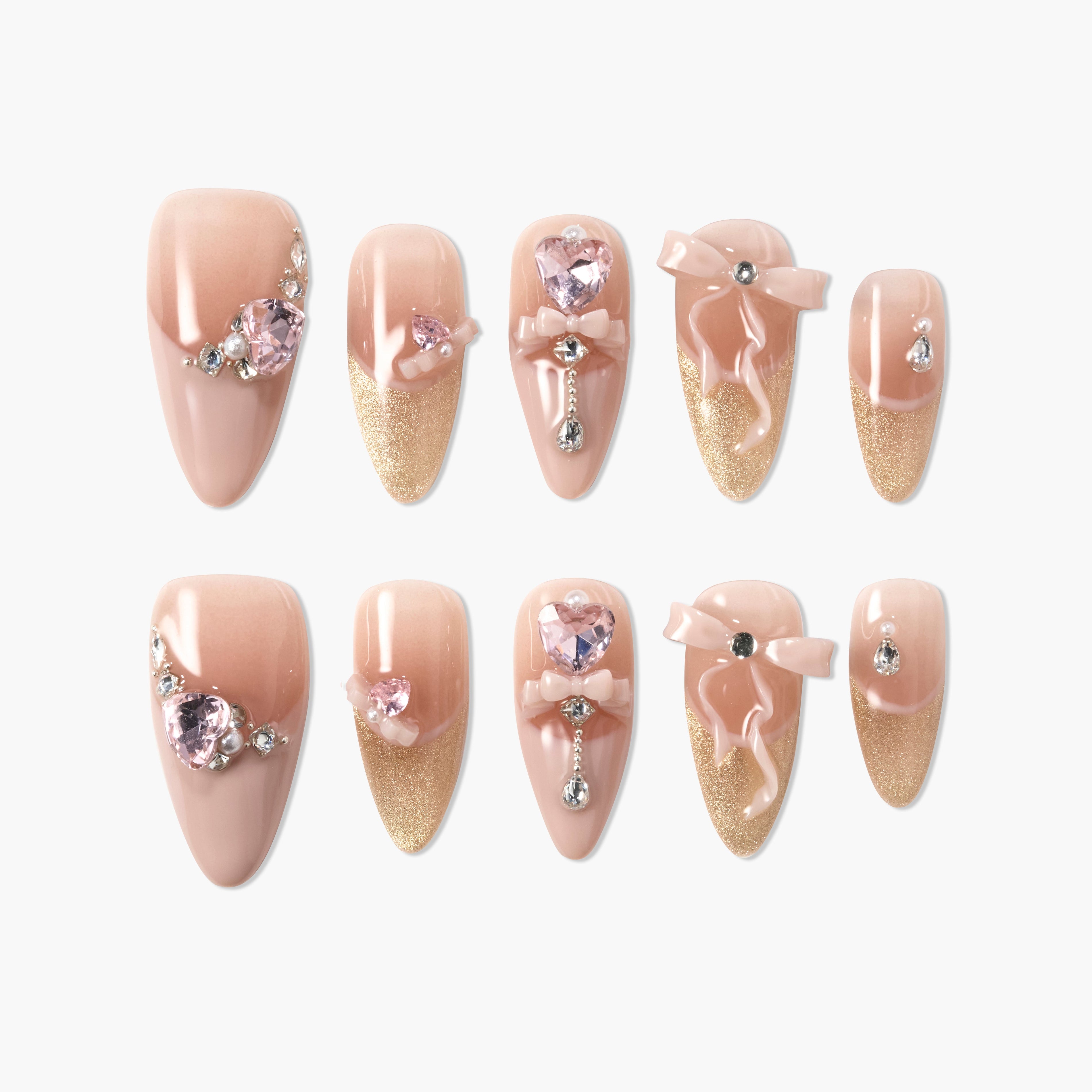 Glitter ombre pink press-on nails with 3D bows, hearts, and rhinestone accents