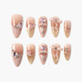 Glitter ombre pink press-on nails with 3D bows, hearts, and rhinestone accents