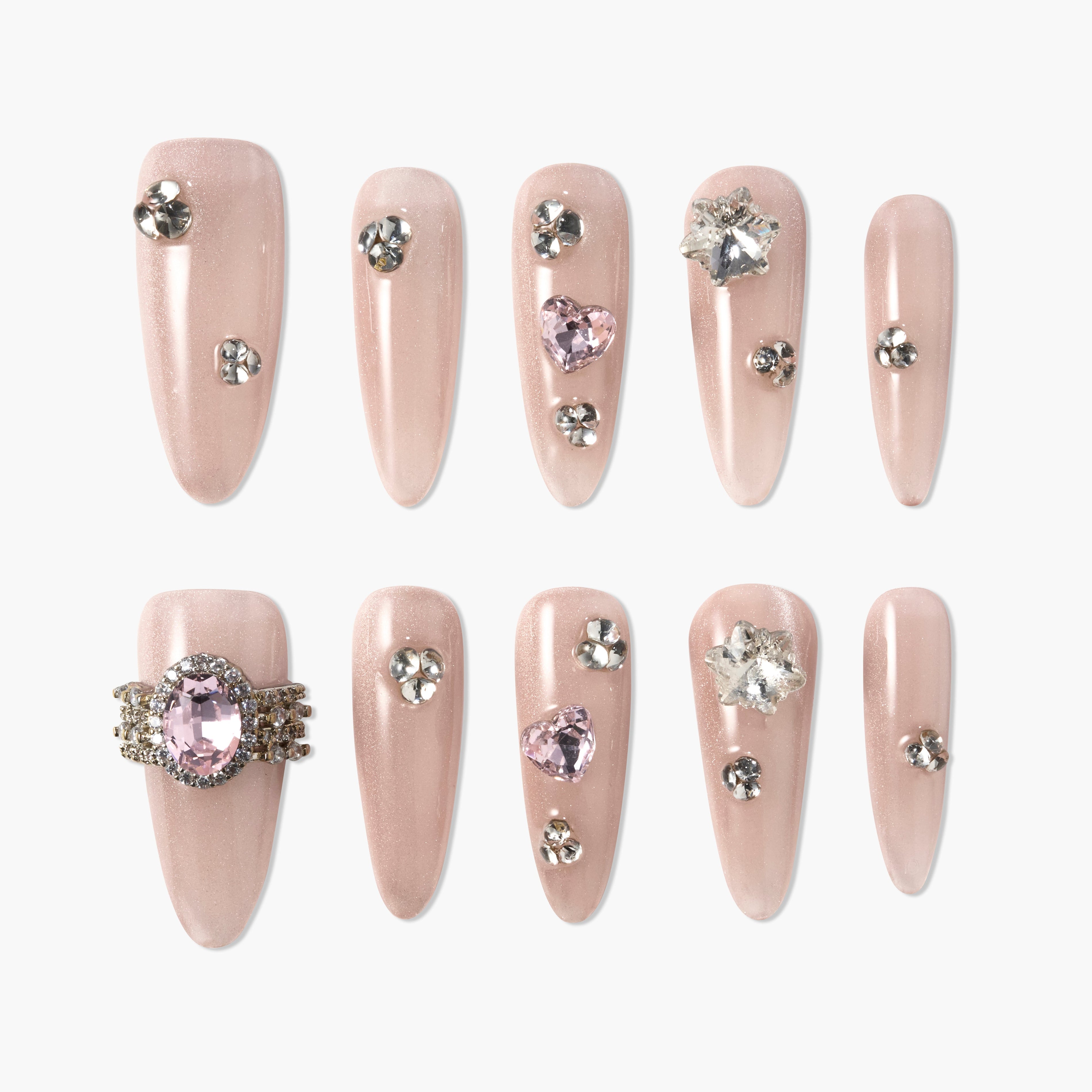 Nude pink press-on nails with rhinestones and gem accents in various shapes