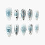 Blue and white handmade press-on nails with 3D floral and silver metallic accents