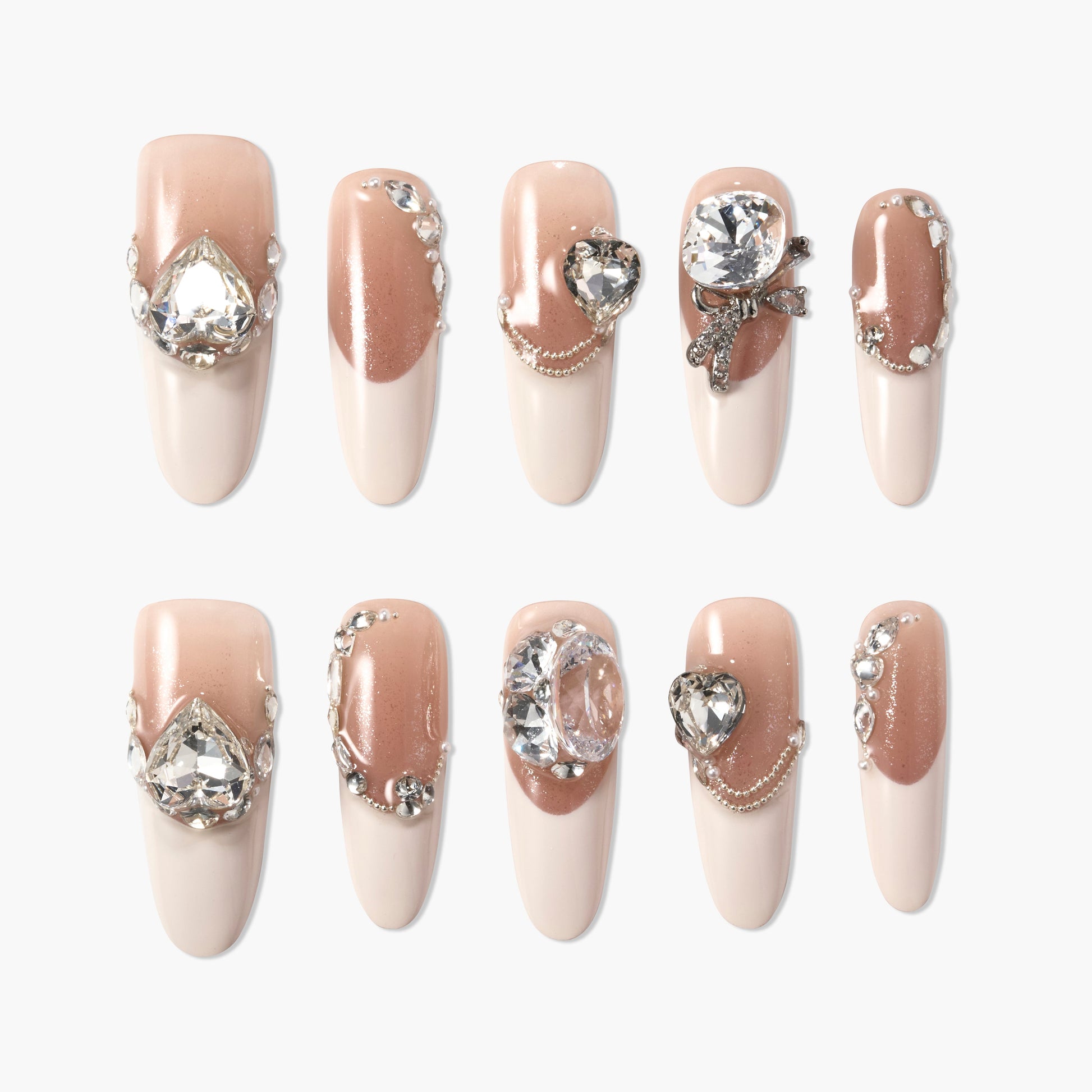 Elegant nude press-on nails with glossy finish, rhinestone and pearl embellishments, and 3D gems.