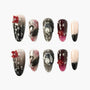 Handmade press-on nails with black, pink, and nude designs, 3D pearls, swans, and red floral accents.