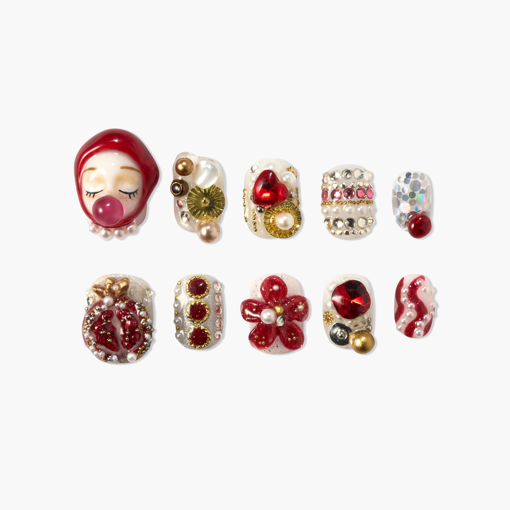 Red and gold Christmas press-on nails with 3D art, gems, and holiday designs on white background.
