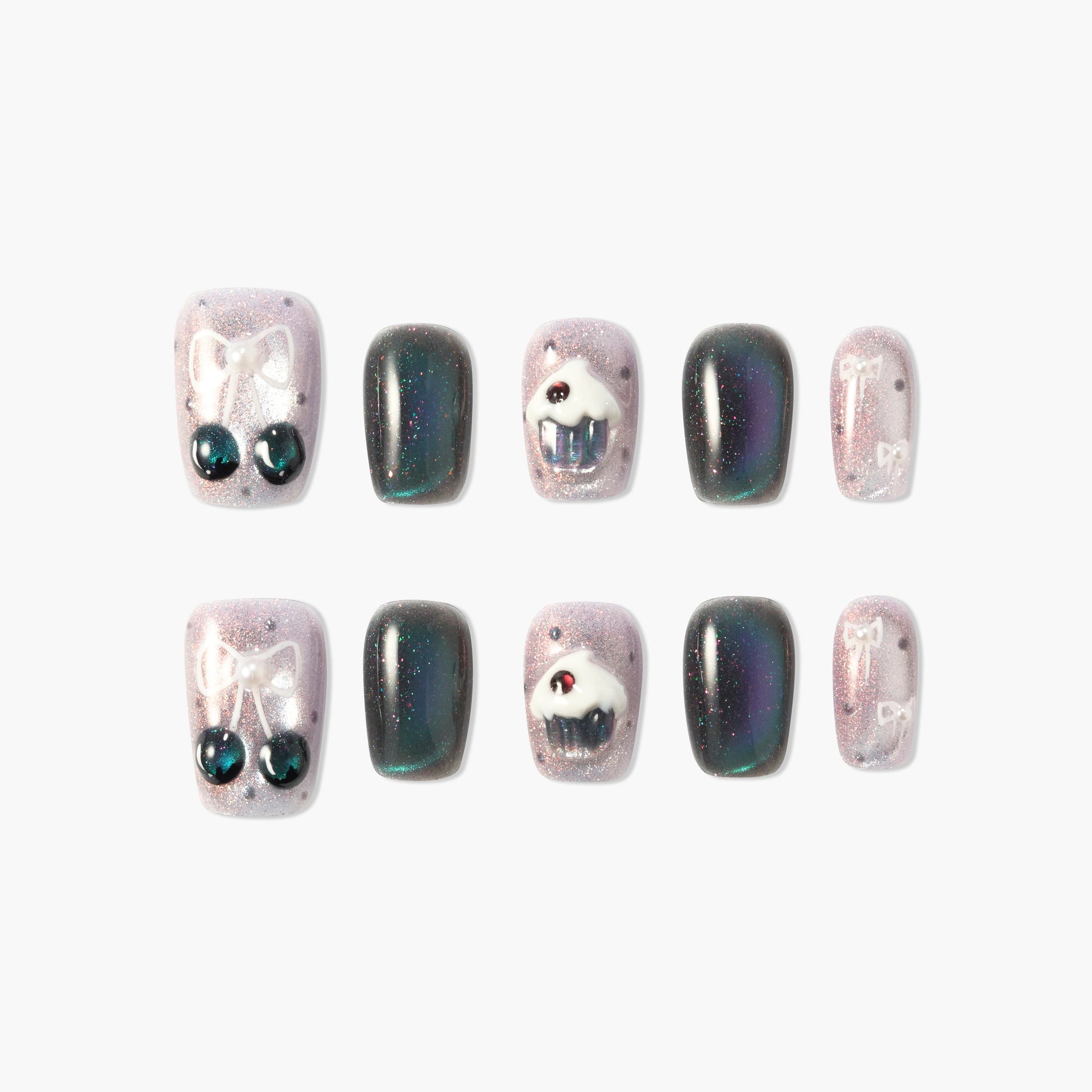 Handmade press-on nails with sparkly pink and black designs, bows, cherries, and cupcake art.