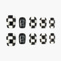 Black and white checkered press-on nails with peace sign accent design