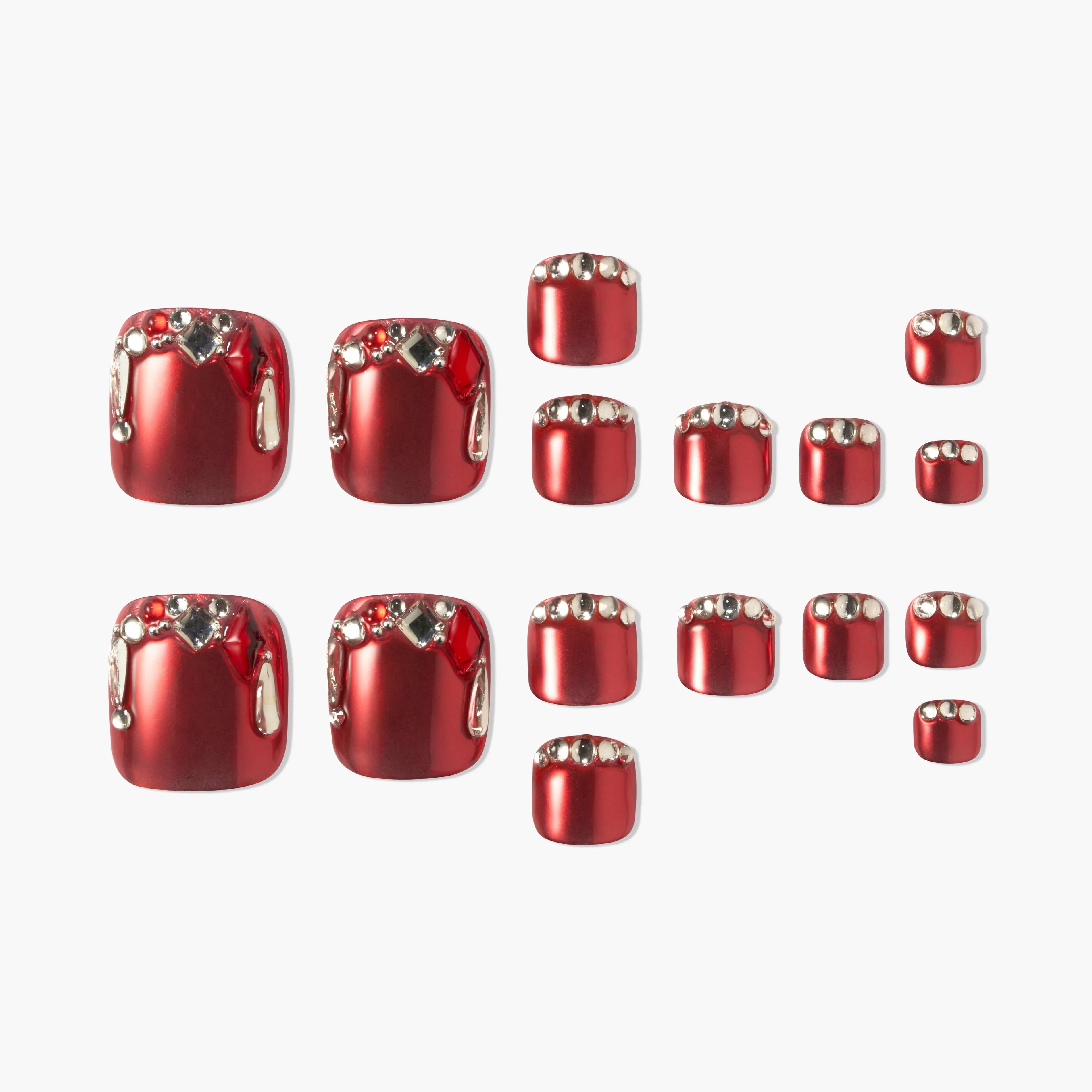 Red press-on toenails with silver rhinestone accents, arranged on a white background.