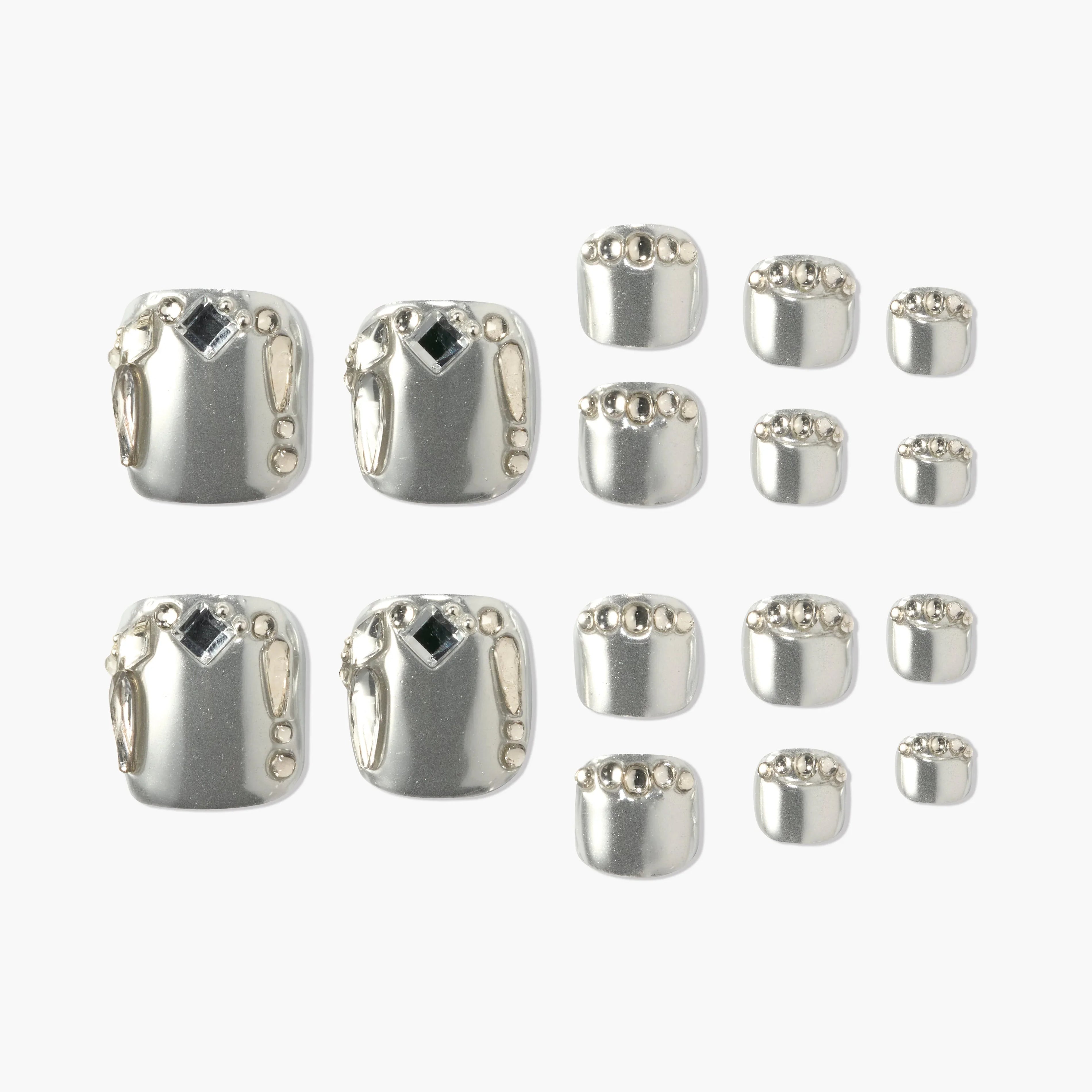 Silver press-on nails set with metallic gems and geometric accents, displayed on white background.