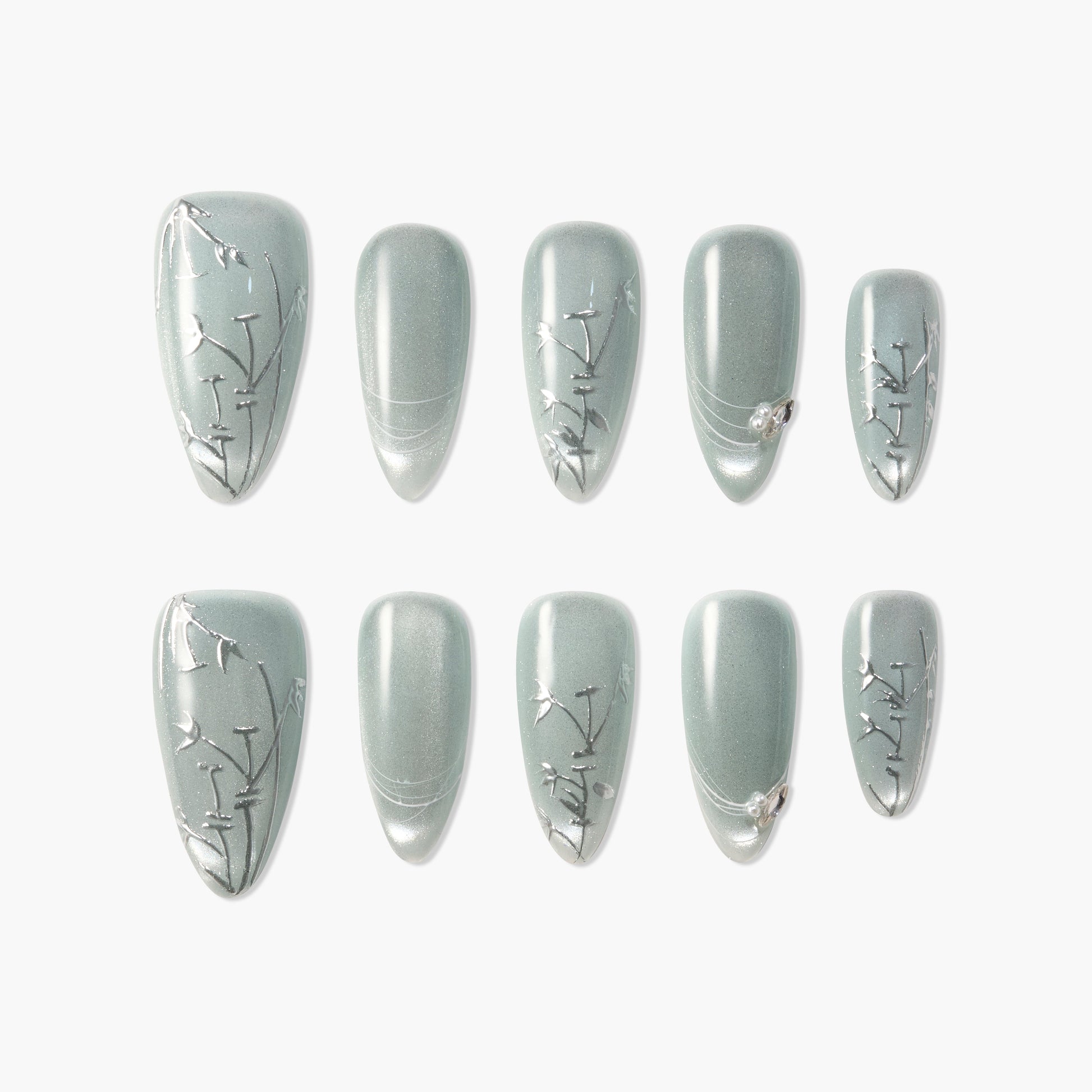 Matte sage green press-on nails with delicate silver floral designs and accent gems