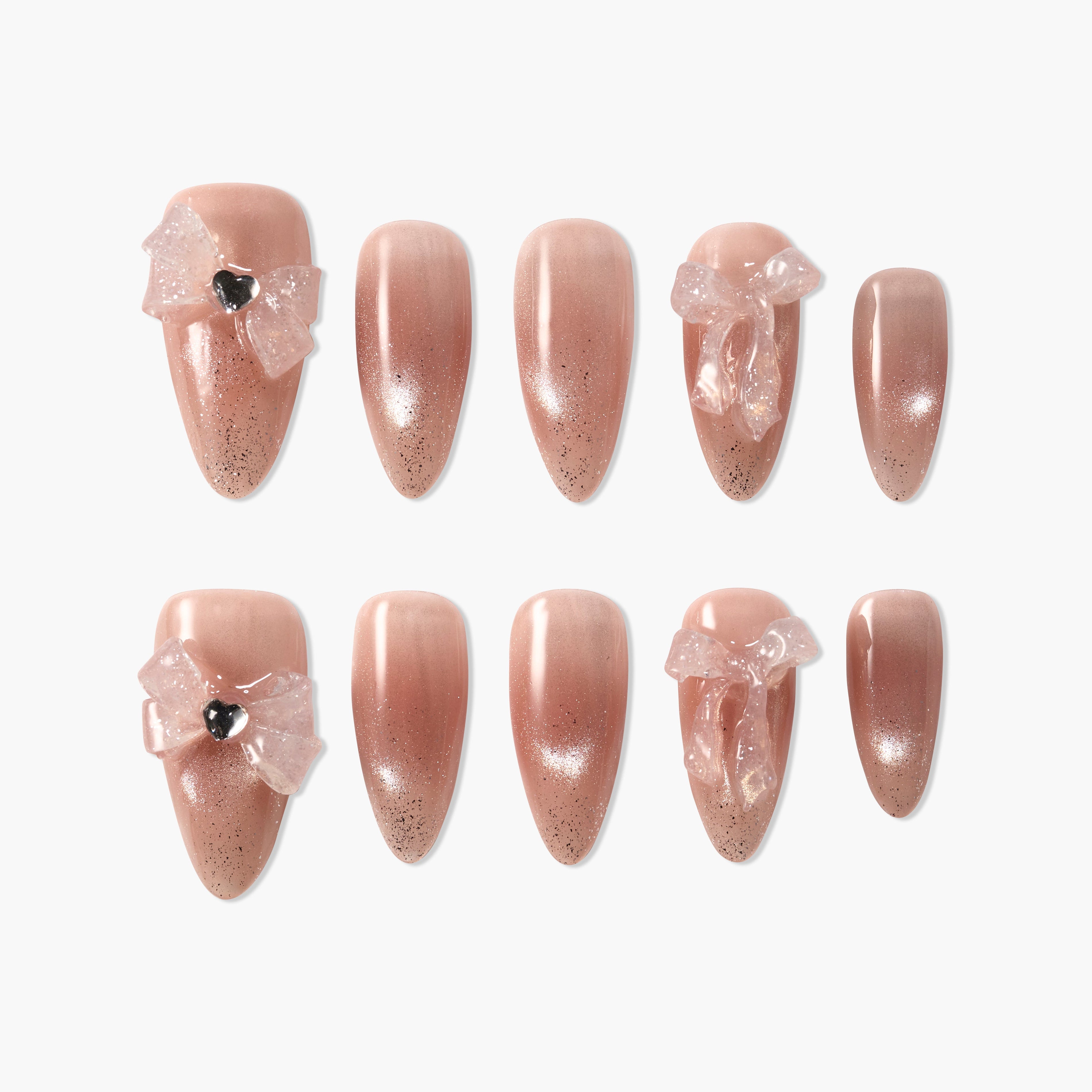 Handmade nude pink press-on nails with glitter and 3D bows, elegant salon-style design