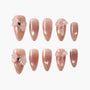 Handmade nude pink press-on nails with glitter and 3D bows, elegant salon-style design