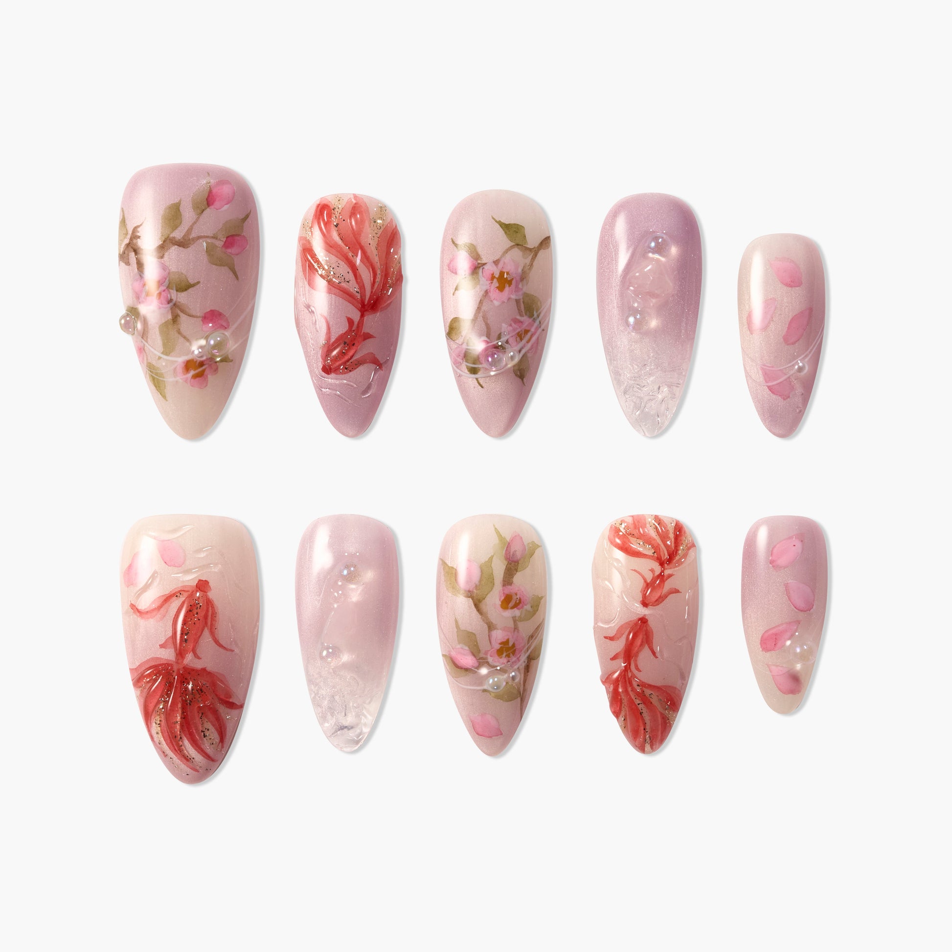 Handmade press-on nails with pink floral designs, gold accents, and pearl embellishments