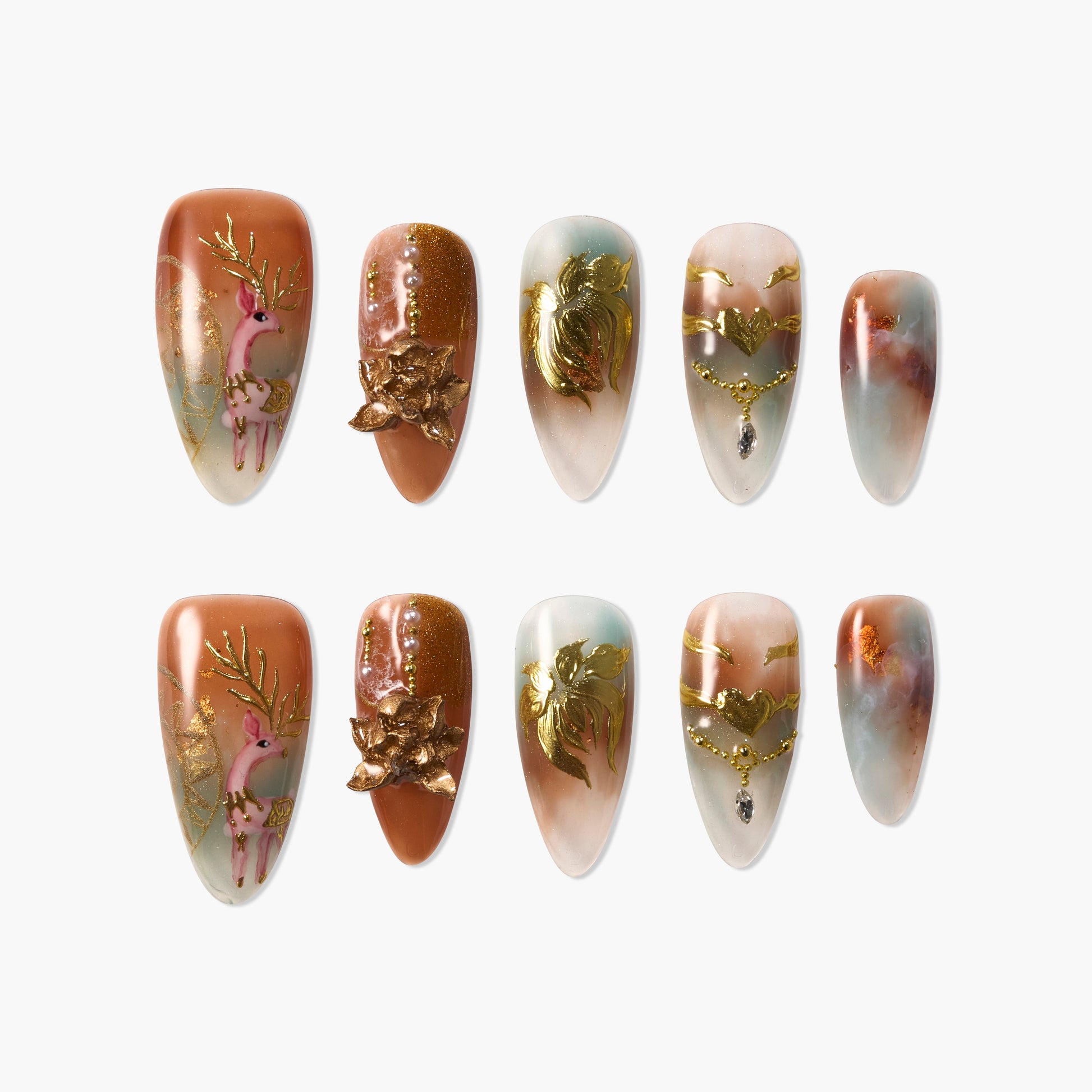 Handmade press-on nails set with gold reindeer, floral, and marble designs on mixed pastel hues