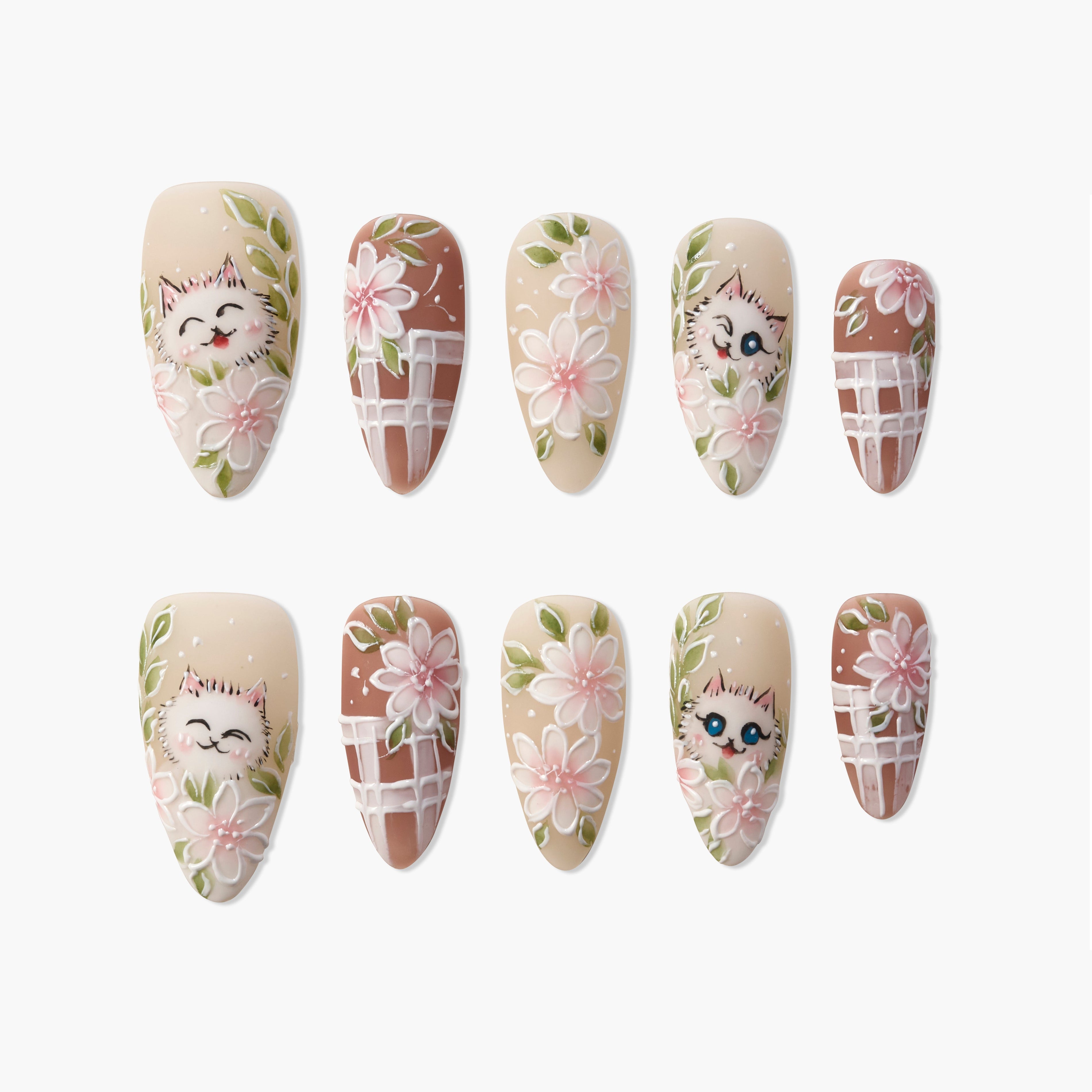 Handmade press-on nails with cute cat faces and pink floral designs on beige and brown backgrounds