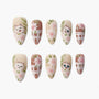 Handmade press-on nails with cute cat faces and pink floral designs on beige and brown backgrounds