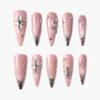 Pink press-on nails with silver floral 3D design and rhinestone accents, glossy finish