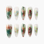Handmade press-on nails with pink floral and green watercolor design, long almond shape