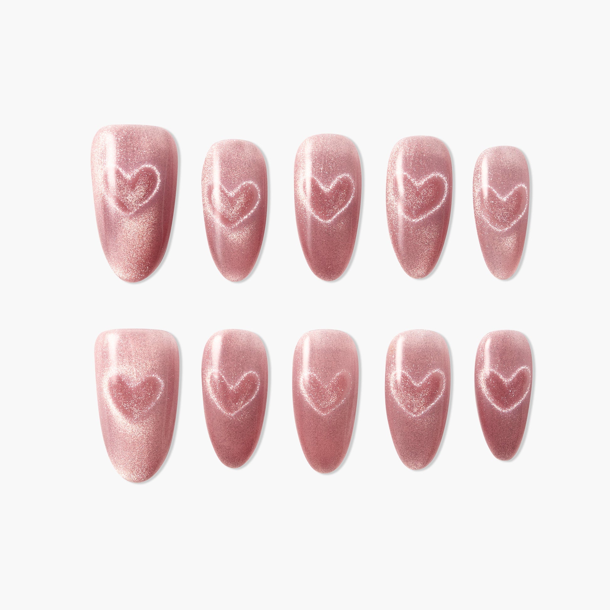 Set of shimmery pink press-on nails with heart design on white background