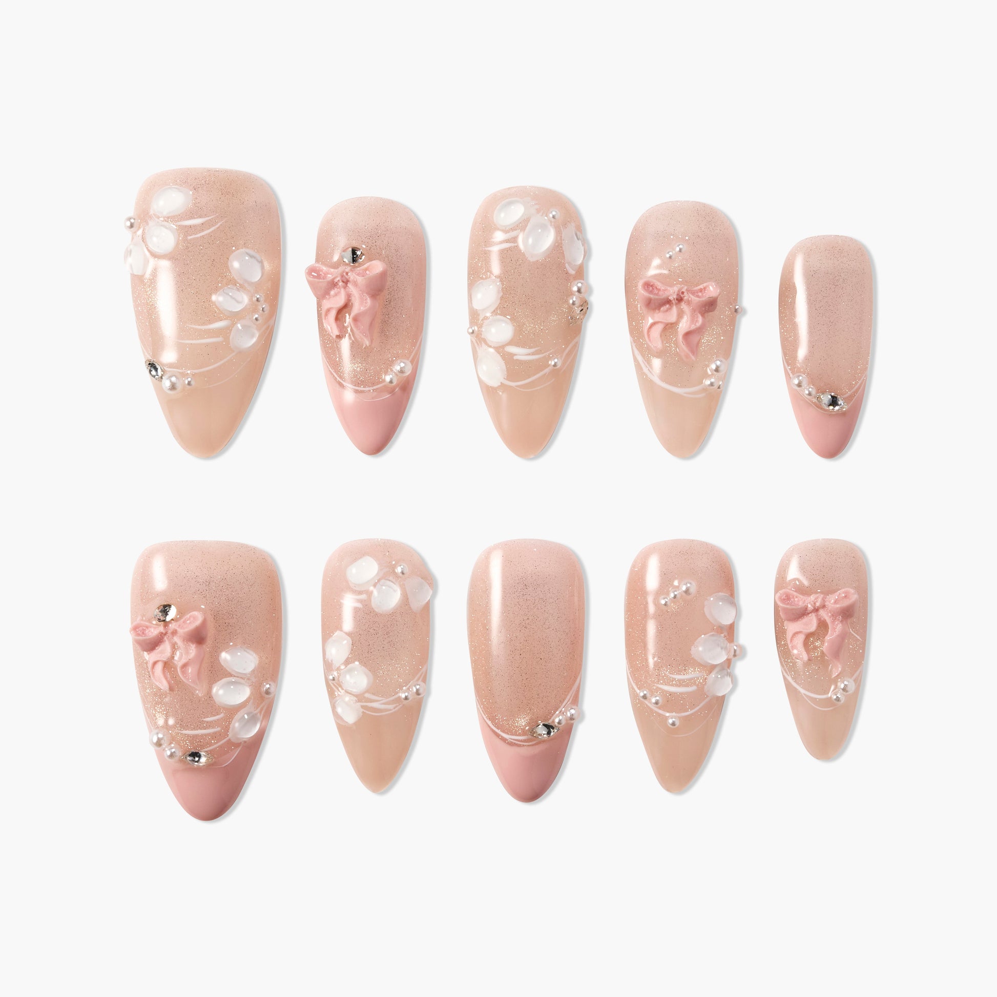 Handmade press-on nails in nude pink with 3D bows, pearls, and white floral accents