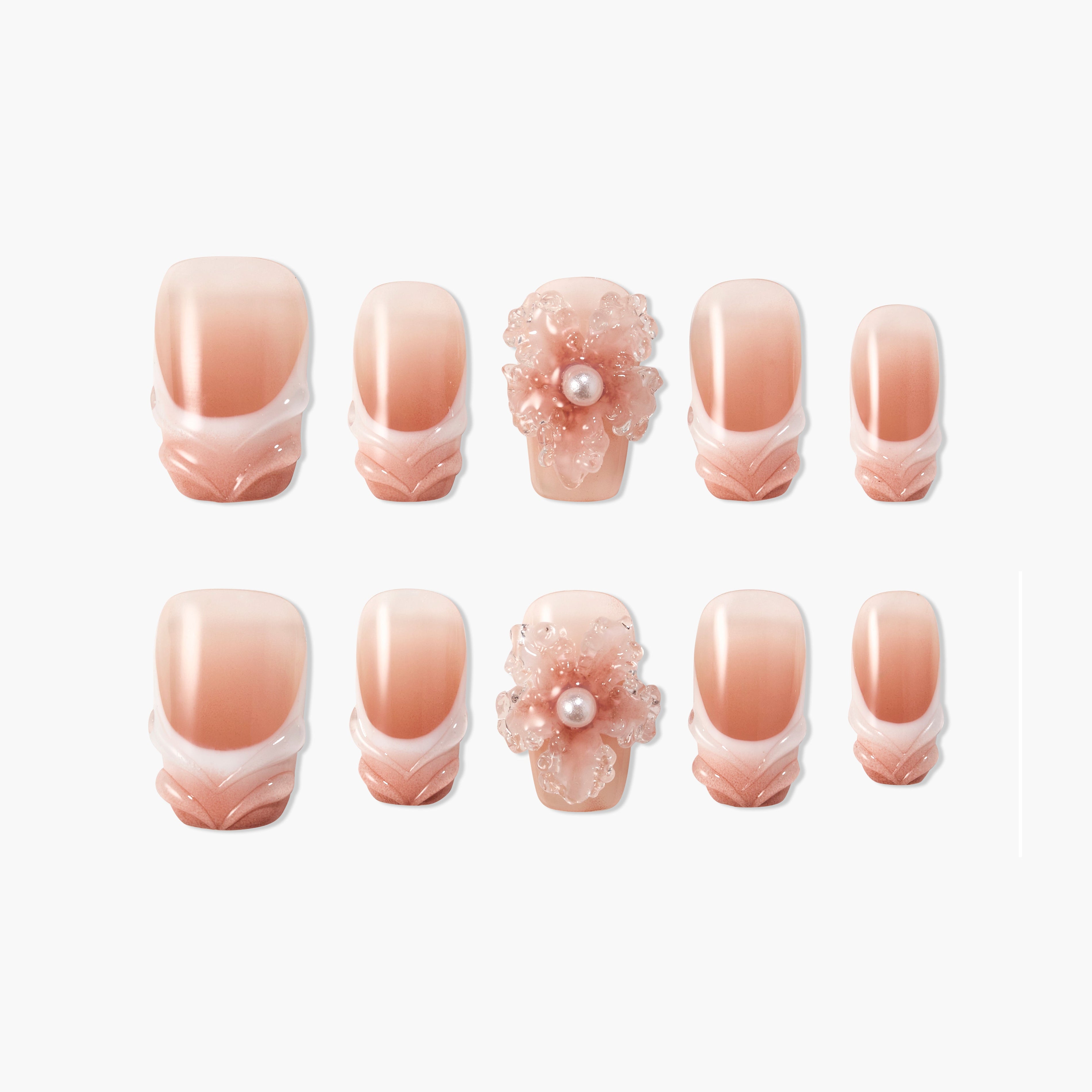Handmade blush pink press-on nails with 3D floral pearl accent and white gradient tips.