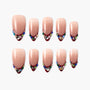 Handmade press-on nails with nude base, burgundy tips, and multicolored gem accents