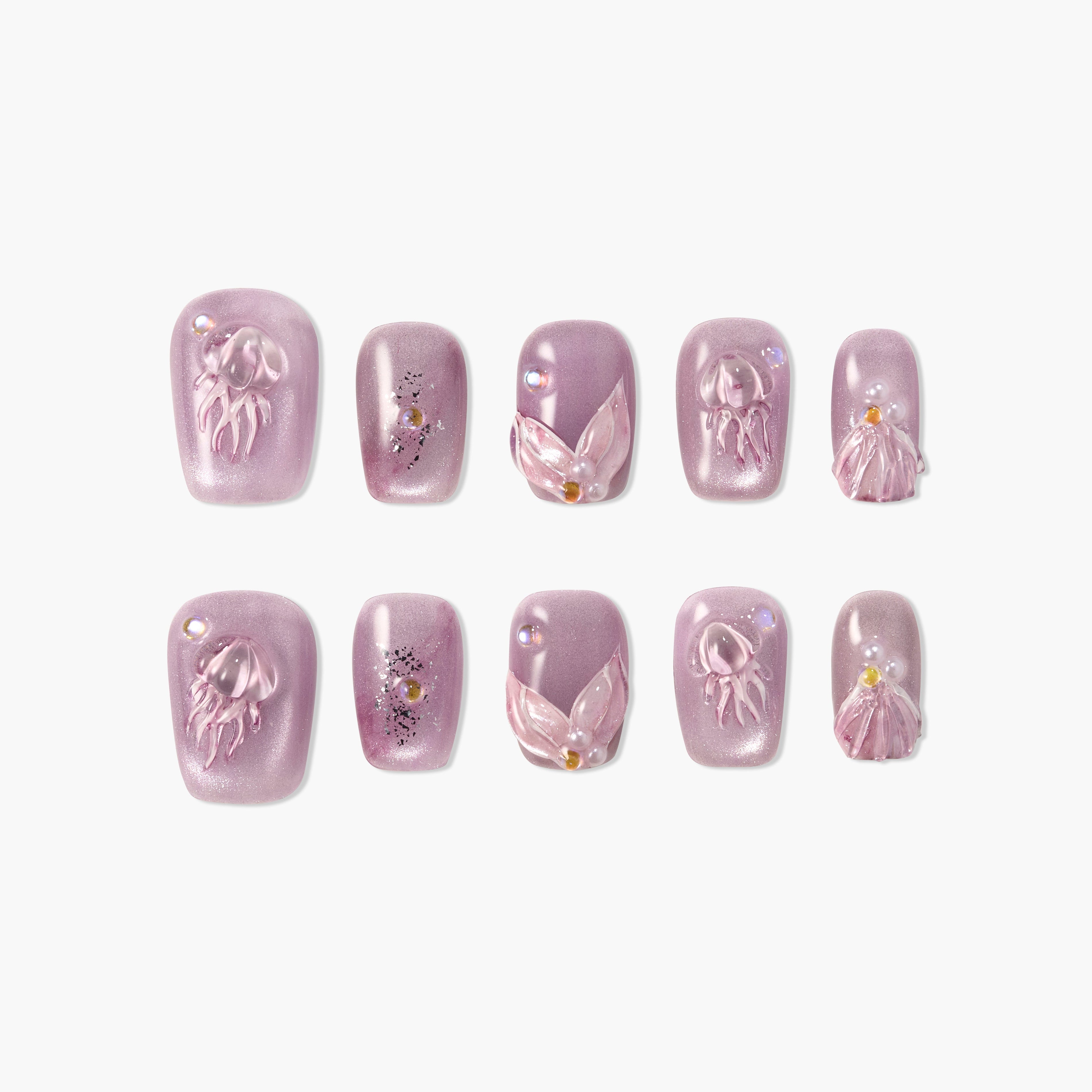 Purple press-on nails with 3D jellyfish, seashell, and pearl accents on white background