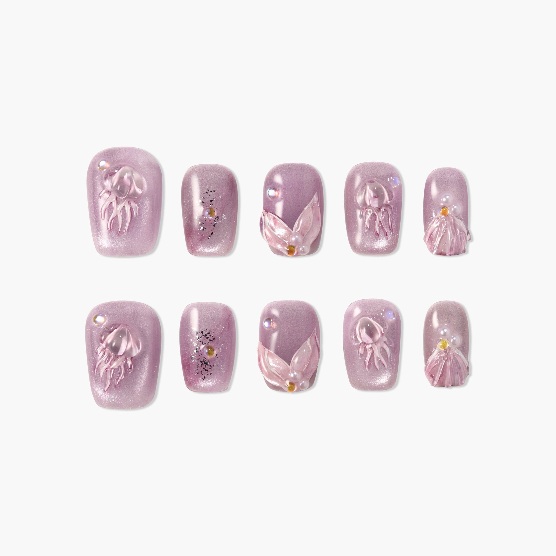 Purple press-on nails with 3D jellyfish, seashell, and pearl accents on white background
