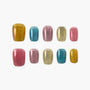 Multicolor glitter press-on nails set with gold, teal, pink, and beige salon designs