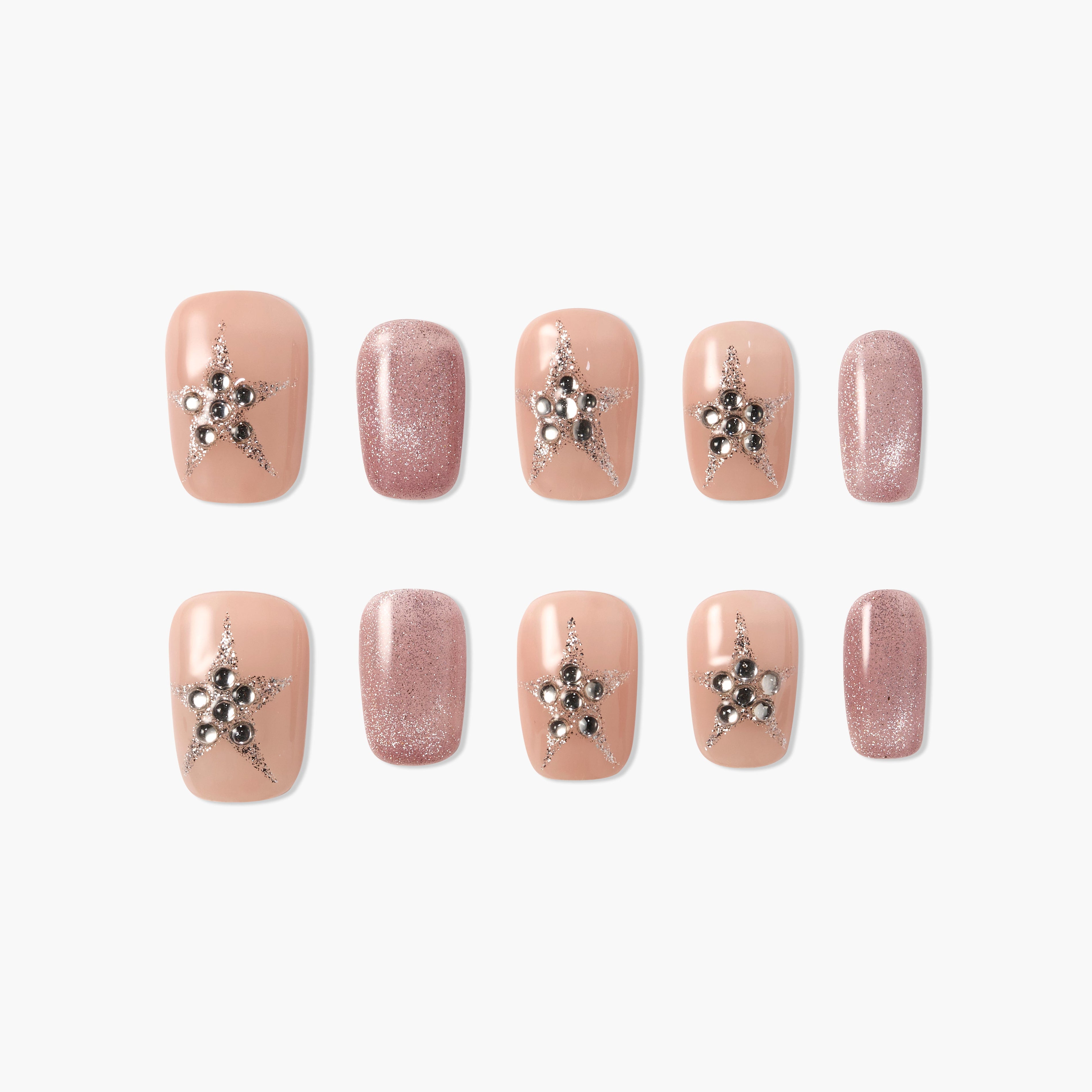 Handmade nude press-on nails with silver star and pearl accents, plus glitter pink nails.
