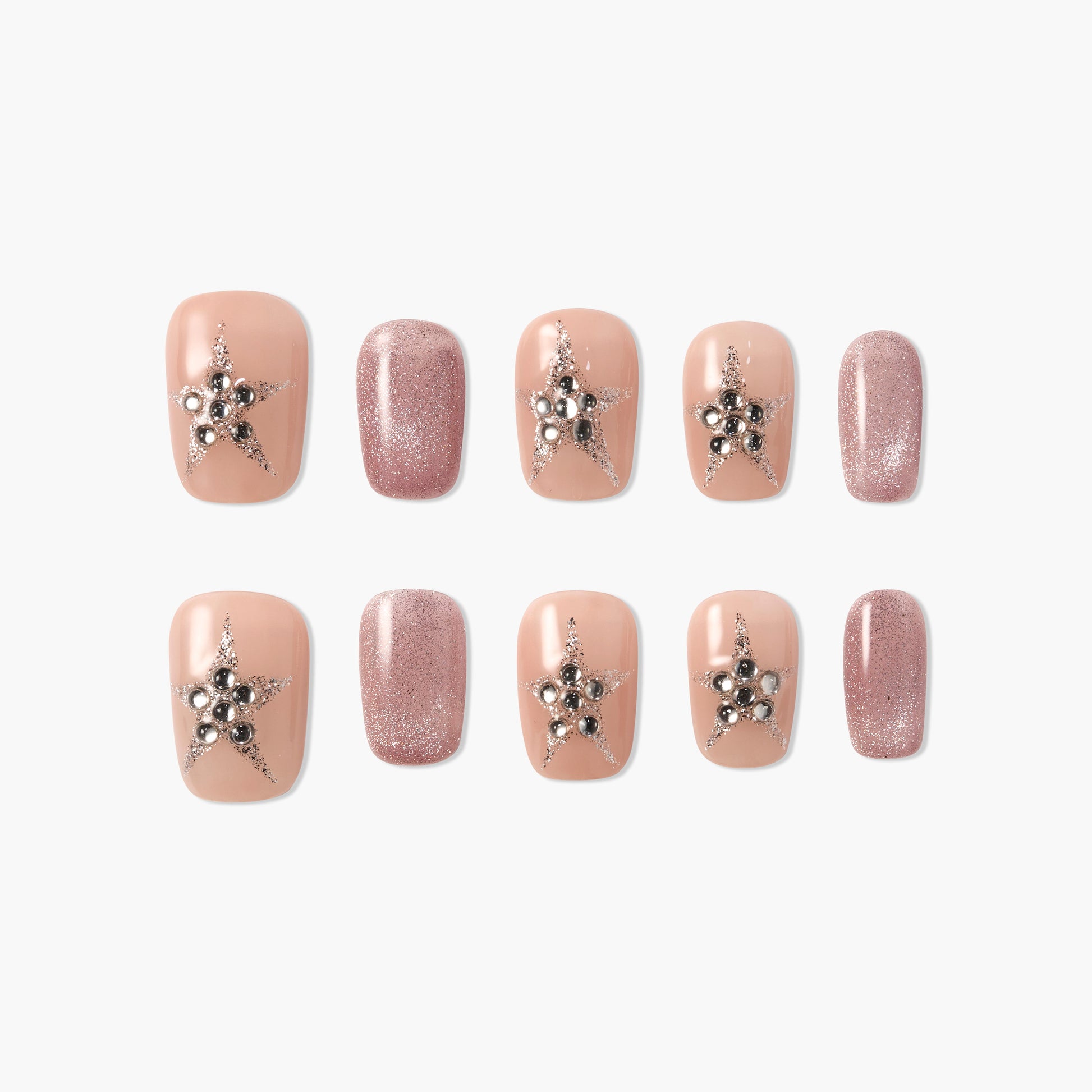 Handmade nude press-on nails with silver star and pearl accents, plus glitter pink nails.