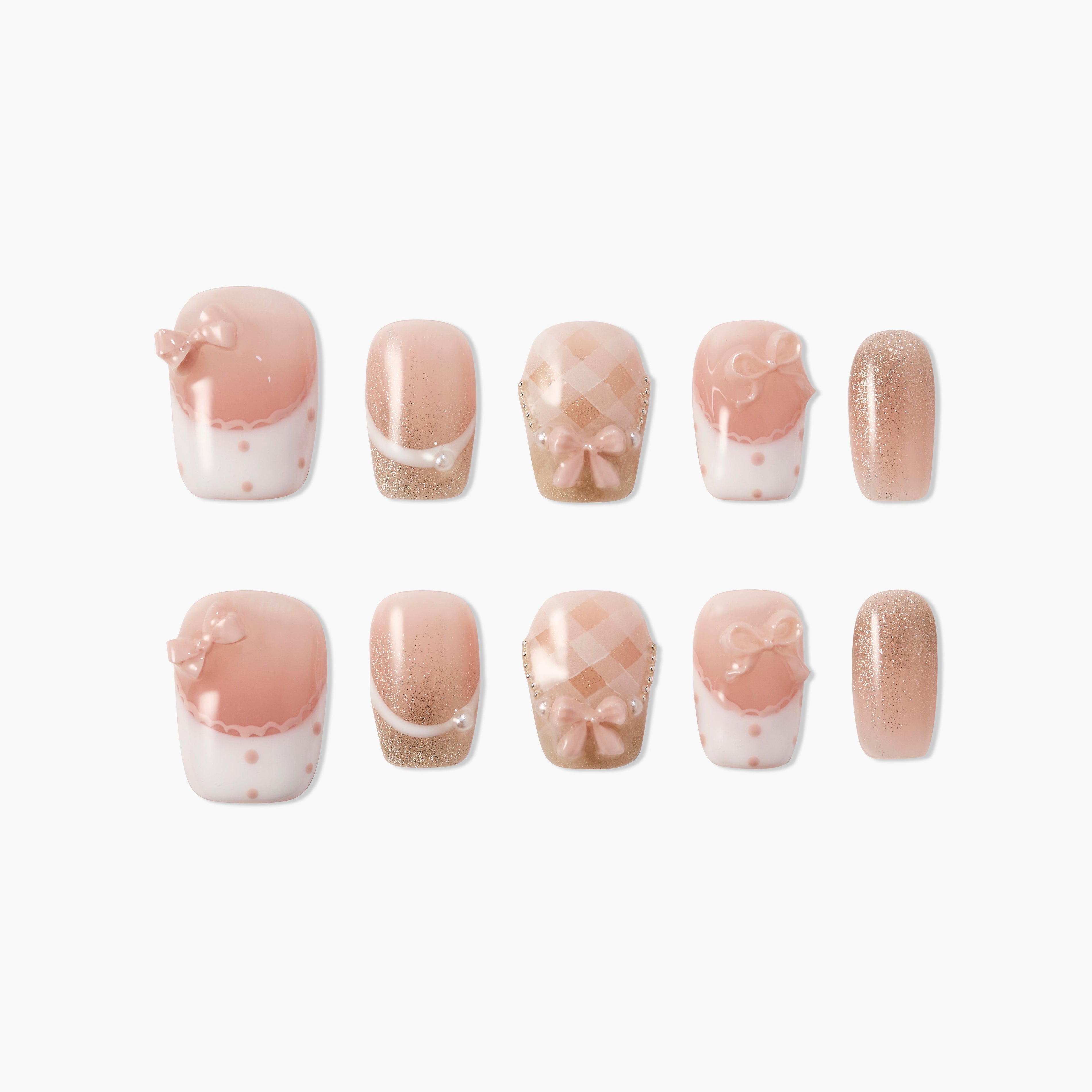 Pink and nude press-on nails with bows, pearls, glitter, and checkered designs on a white background