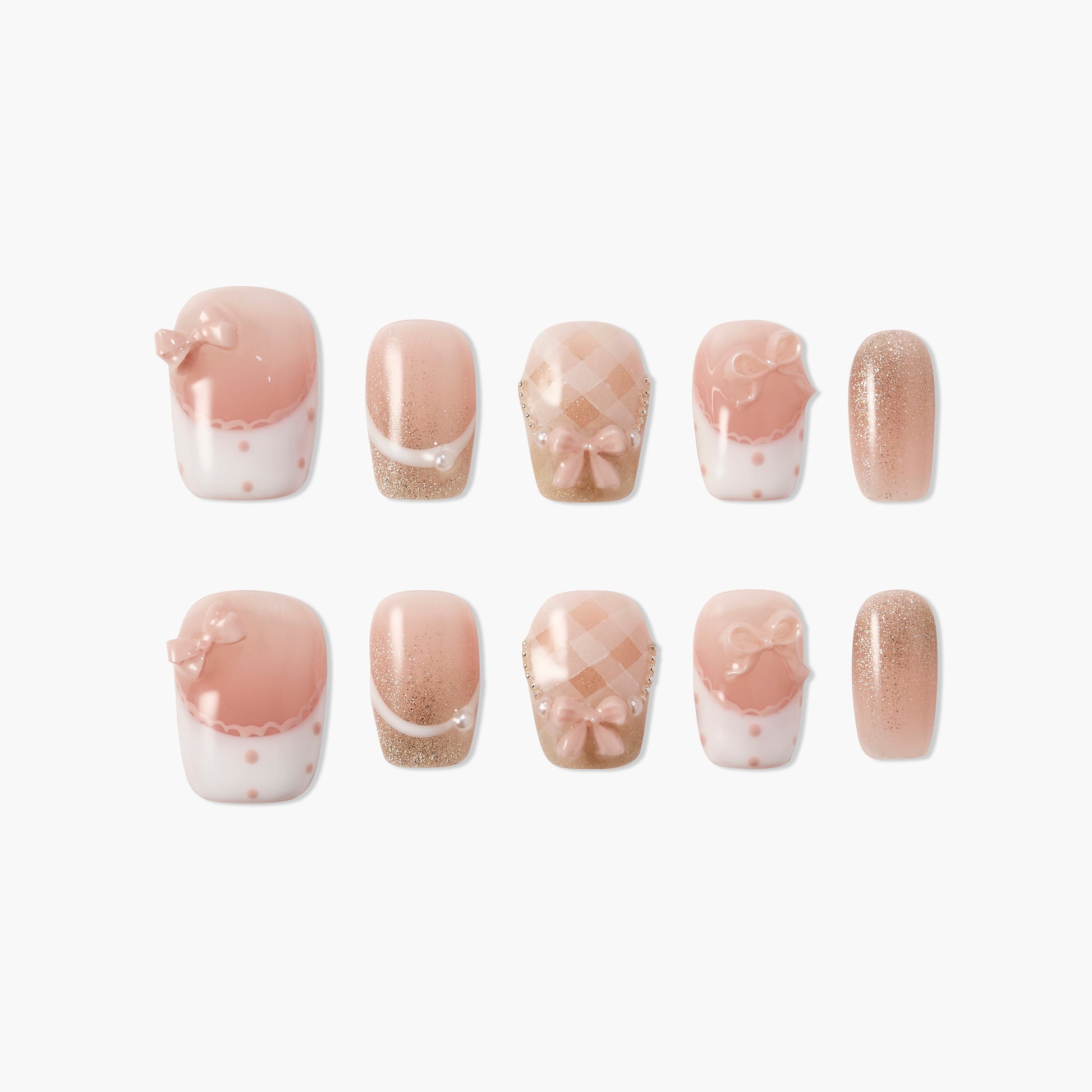 Pink and nude press-on nails with bows, pearls, glitter, and checkered designs on a white background