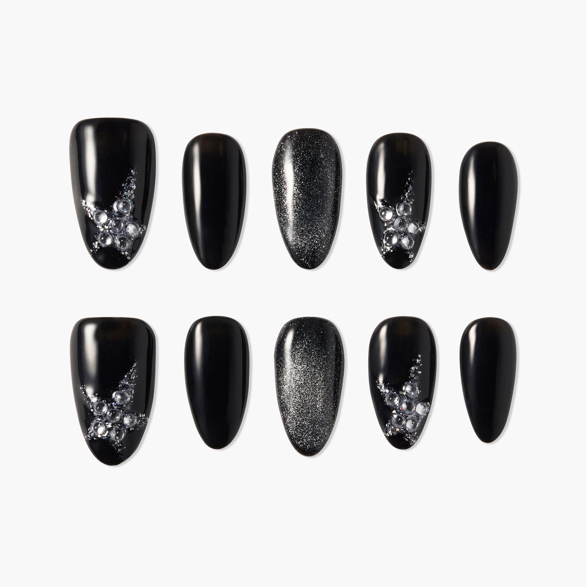 Black press-on nails with glitter and rhinestone star designs, arranged on a white background.