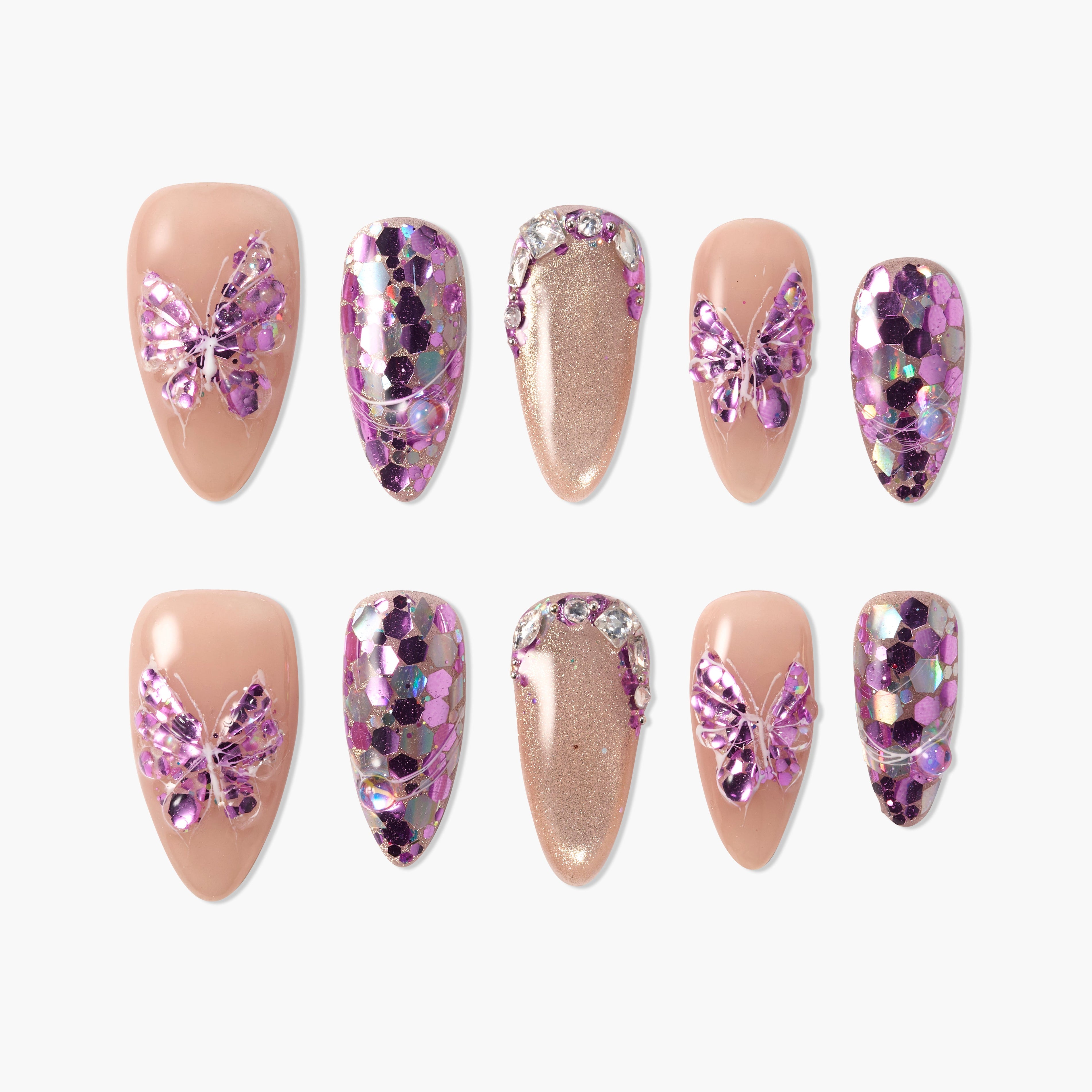 Glossy press-on nails with nude and glitter designs, purple butterfly charms, rhinestone accents