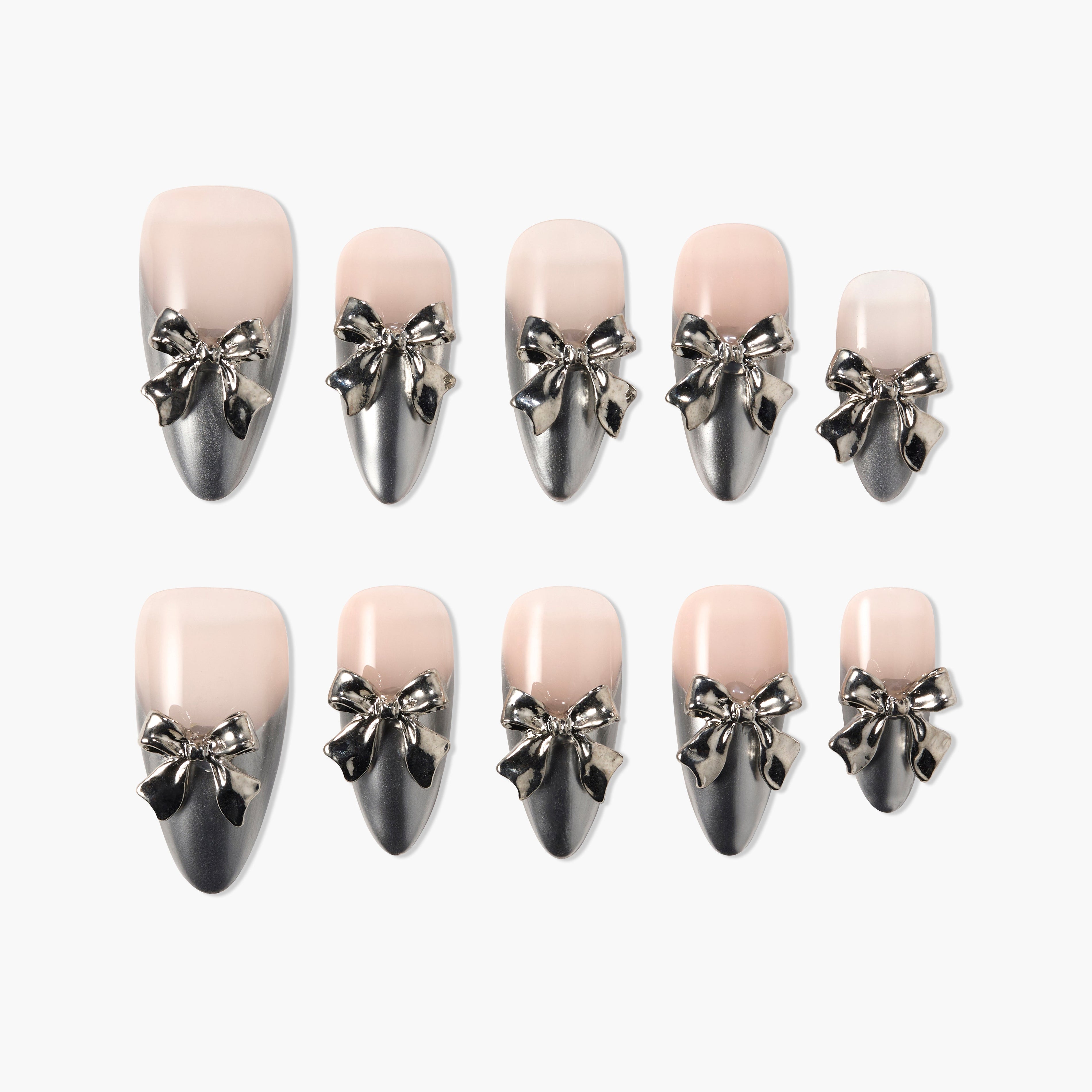 Handmade press-on nails with silver metallic bow accents on nude and black ombré base