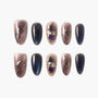 Handmade press-on nails with galaxy design, marble accents, and gold details on white background