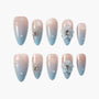 Blue and nude ombre press-on nails with pearls, rhinestones, and 3D floral accents