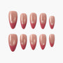 Almond-shaped pink and nude press-on nails set with glossy finish on white background