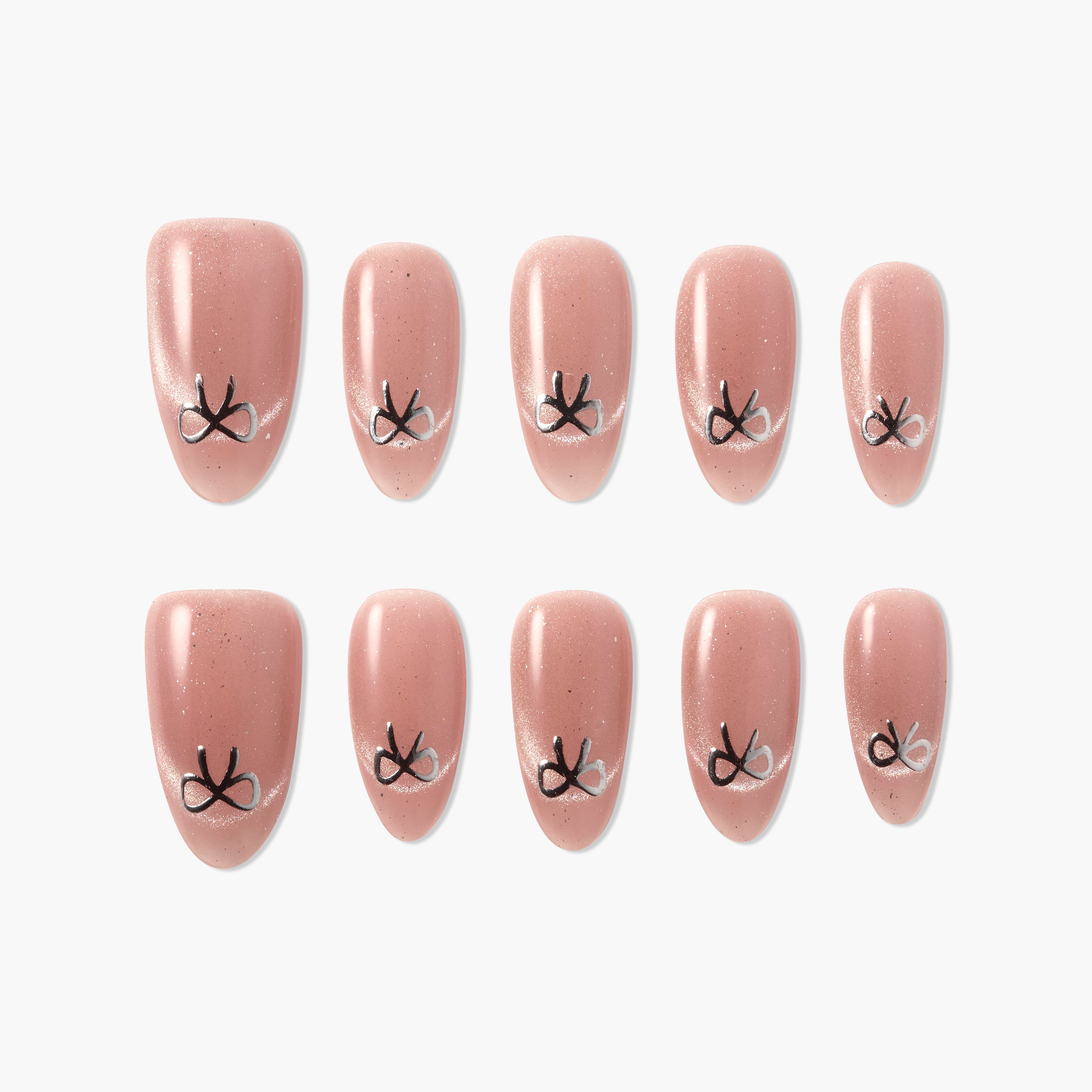 Set of pink press-on nails with black and white bow design, arranged on white background