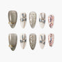 Handmade press-on nails with glitter, pearl accents, bows, and multicolor confetti design