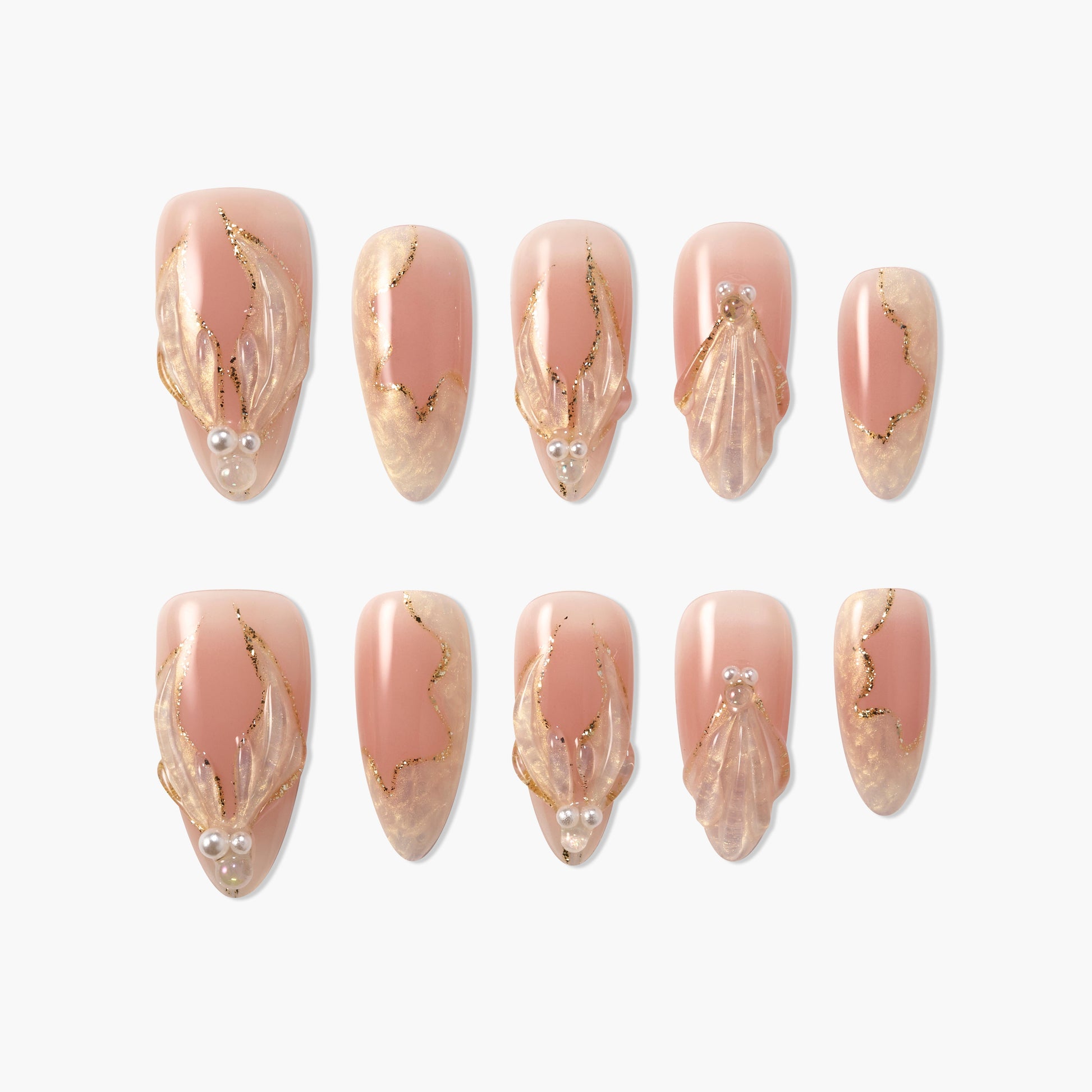 Handmade press-on nails in nude pink with 3D gold accents, pearl details, and marble design