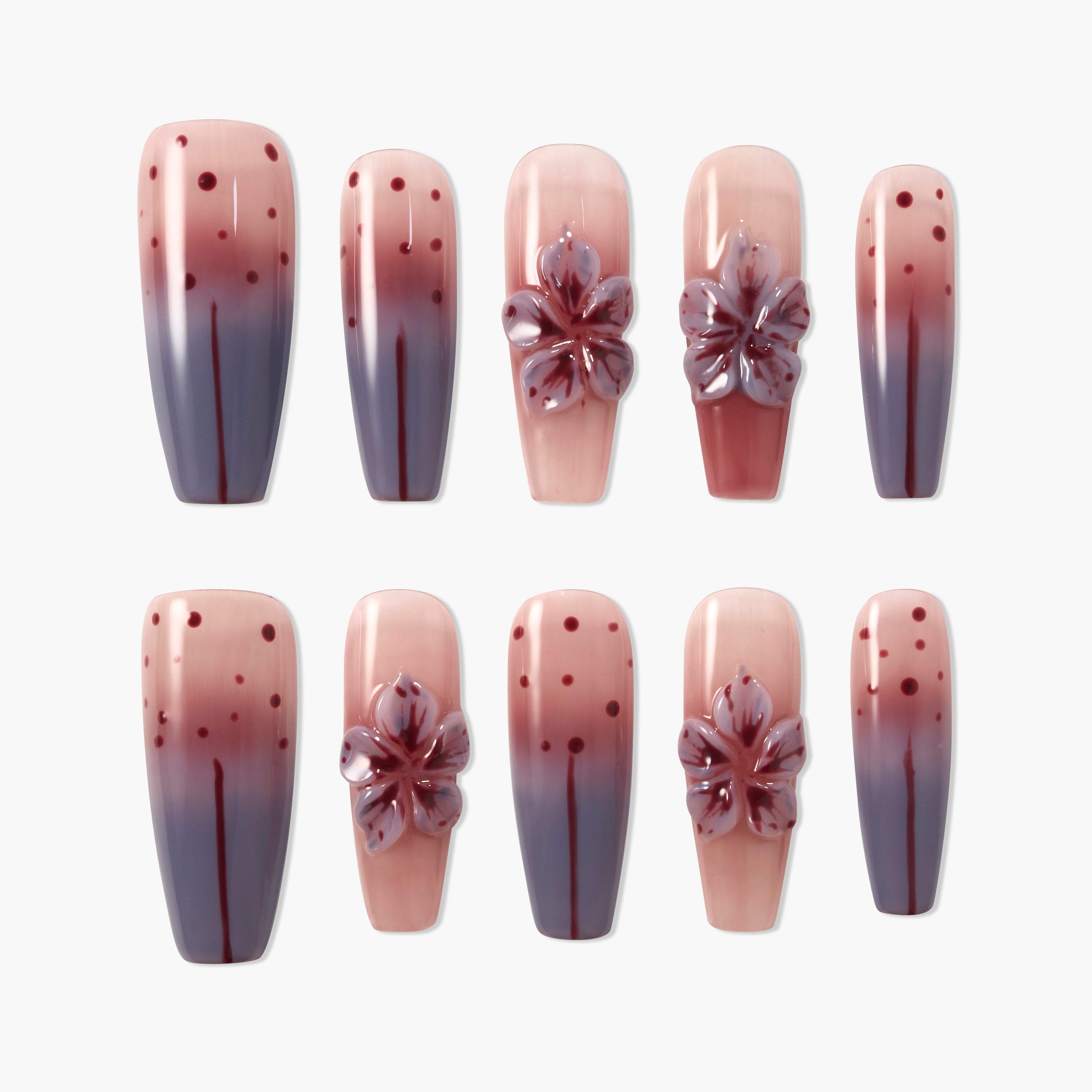 Ombre pink and purple press-on nails with 3D floral accents and polka dot design, glossy finish
