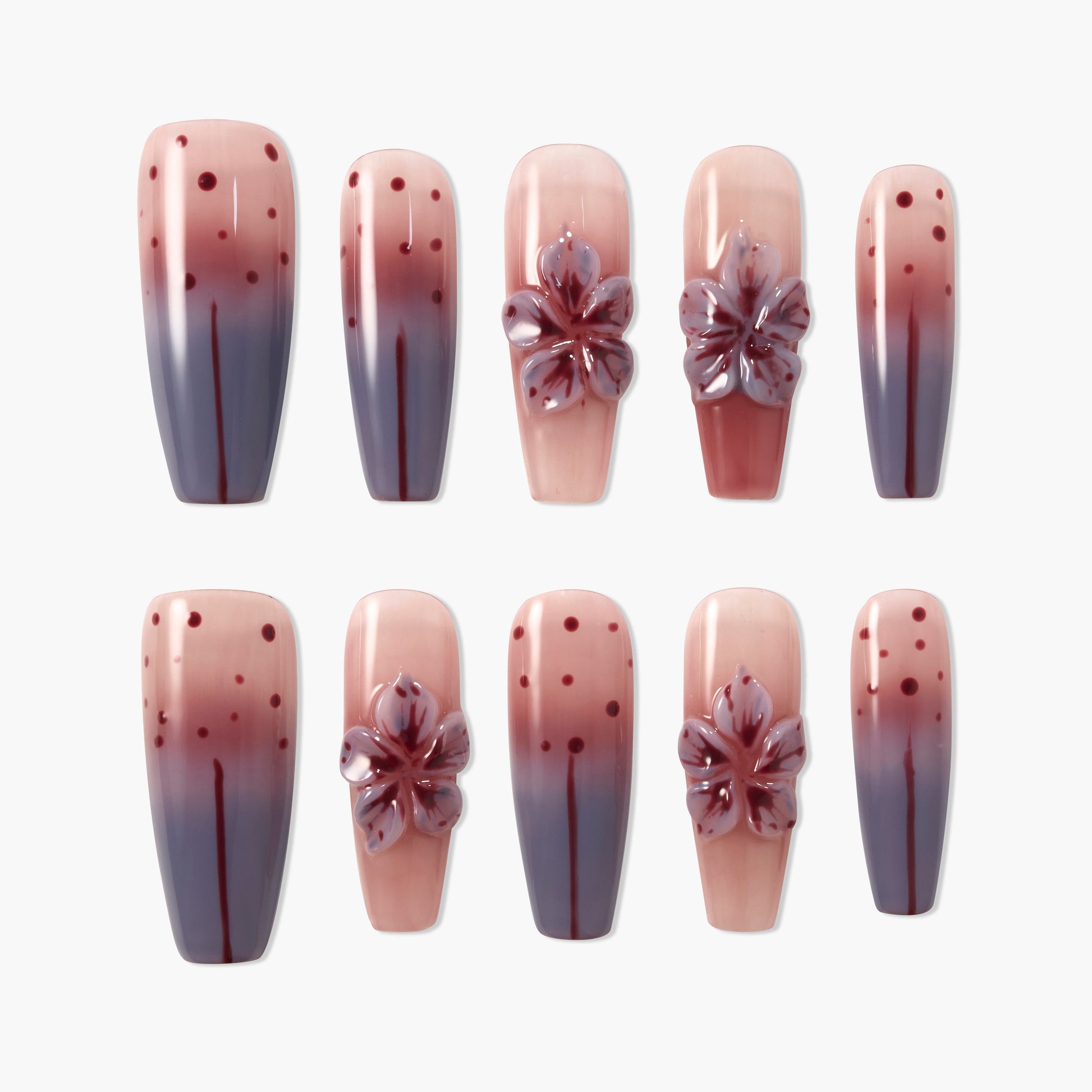 Ombre pink and purple press-on nails with 3D floral accents and polka dot design, glossy finish