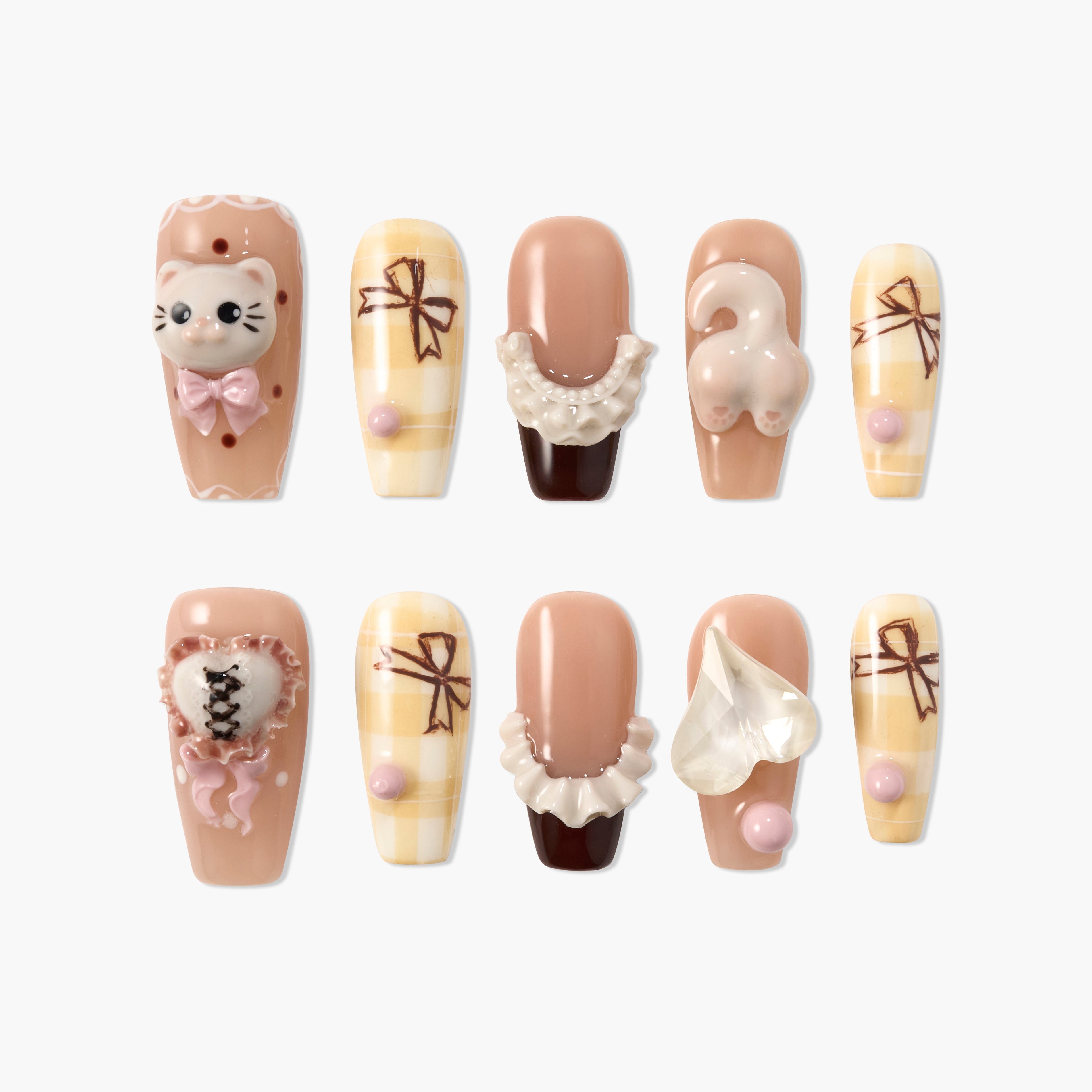 Cute handmade press-on nails with 3D cat, bows, lace, and heart designs in beige and pink tones.