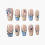 Blue gingham press-on nails with pastel 3D bows, gems, and pearl embellishments
