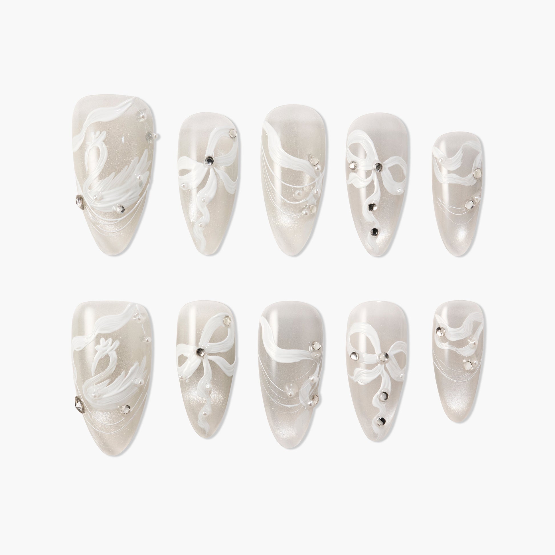 Handmade press-on nails with pearly white base, white swirl designs, and rhinestone accents
