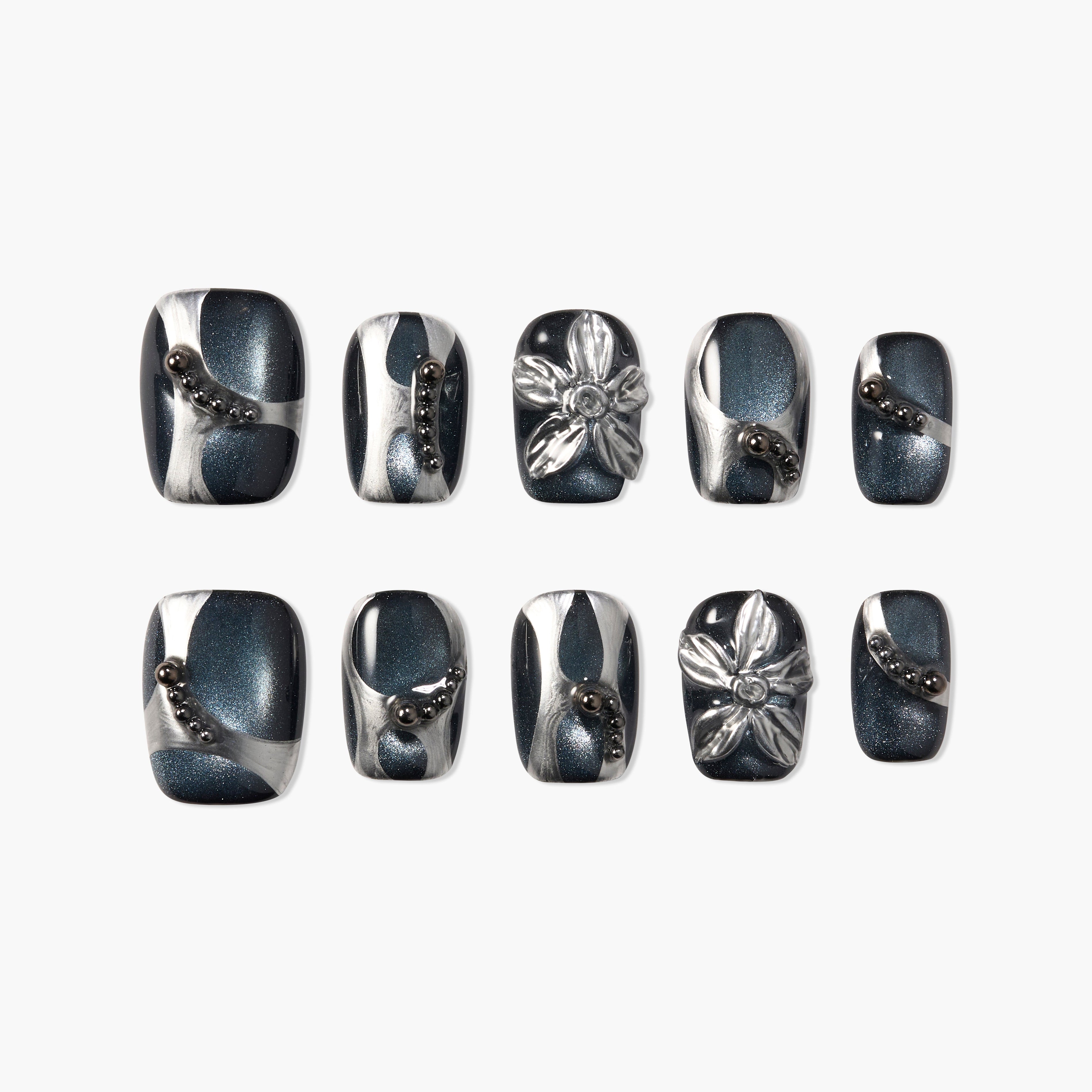 Handmade press-on nails with metallic blue, silver swirls, 3D flowers, and bead accents